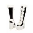 Black and white platform boots with faux fur trim and lace-up design, featuring chunky high heels. Fashionable winter footwear for women.