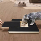 Dog using interactive puzzle toy on wooden floor, enhancing mental stimulation and engagement. Pet enrichment, brain game for dogs, indoor activity.