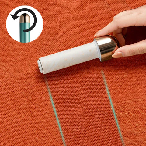 Hand using a reusable lint roller on orange fabric, showcasing easy pet hair and dust removal. Eco-friendly cleaning tool with rotating handle.