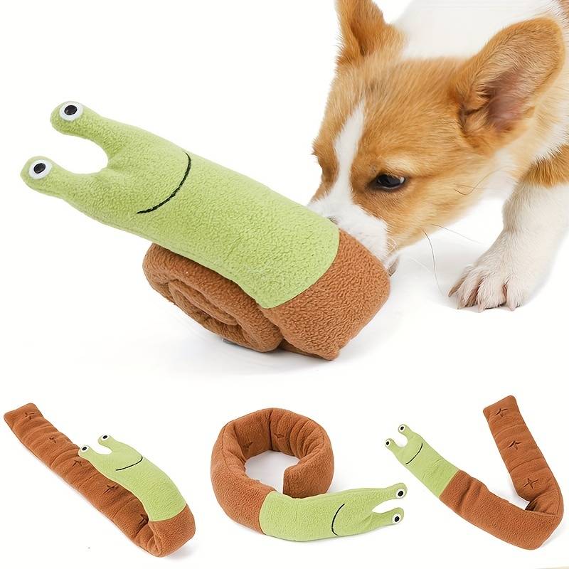 Corgi puppy playing with a green and brown snail-shaped plush dog toy. Soft, durable pet toy for interactive play and chewing. Perfect for small dogs.