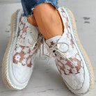 Stylish white floral lace shoes with beige soles, perfect for casual wear. Trendy women's footwear, breathable design, ideal for spring and summer.