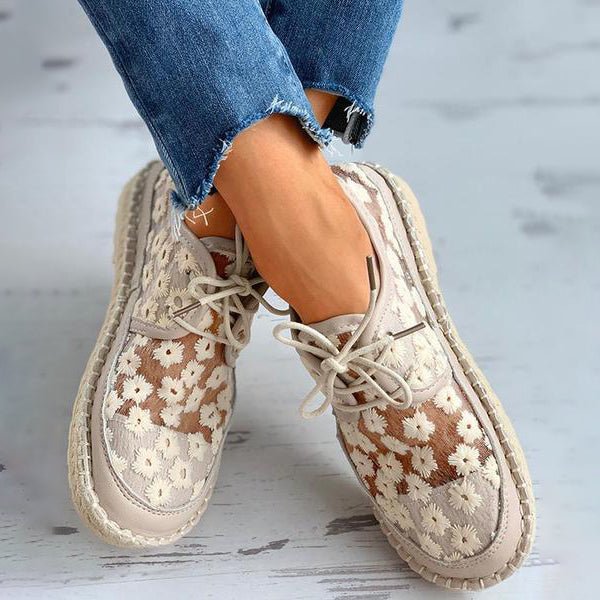 Stylish women's shoes with floral pattern, breathable mesh design, beige color, paired with frayed hem jeans. Perfect for casual spring fashion.