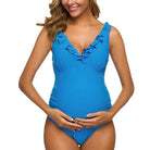 Maternity swimwear in blue with ruffled neckline, designed for pregnant women. Comfortable, stylish one-piece swimsuit for beach or pool.