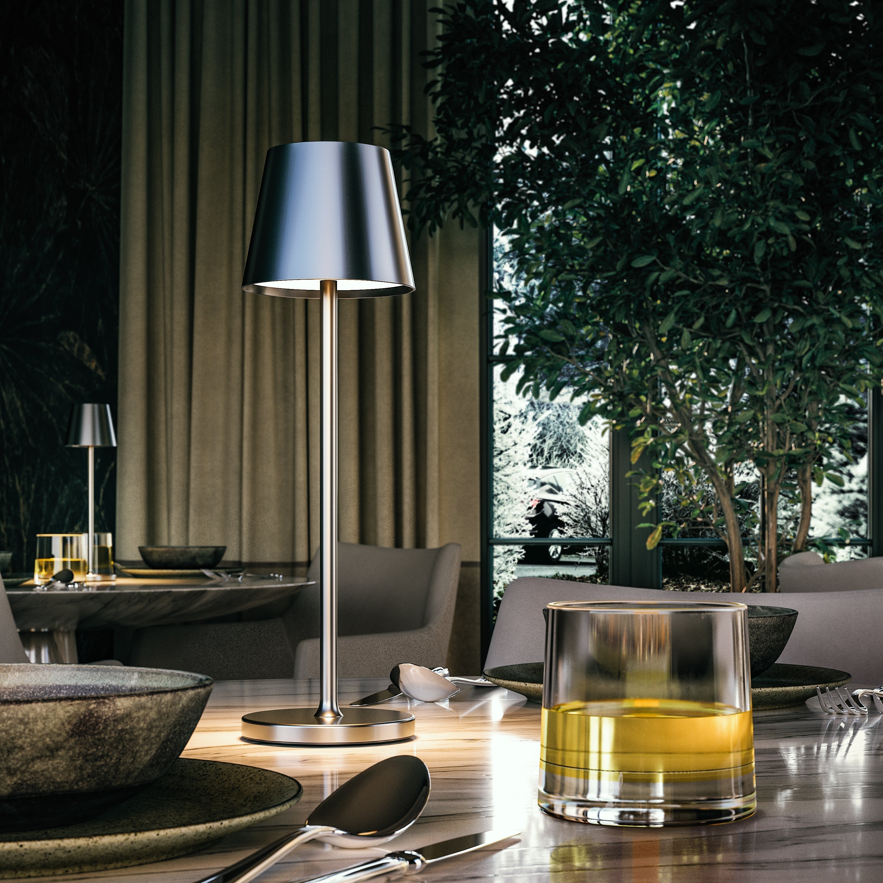 Sleek silver table lamp on elegant dining table with modern decor, surrounded by lush greenery and ambient lighting. Perfect for contemporary interiors.