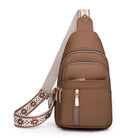 Brown leather crossbody sling bag with adjustable patterned strap, multiple zippered pockets, and gold-tone hardware. Stylish and functional accessory.