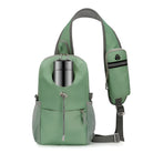 Green sling backpack with water bottle holder, adjustable strap, and mesh side pockets. Ideal for hiking, travel, and outdoor activities. Durable and stylish.