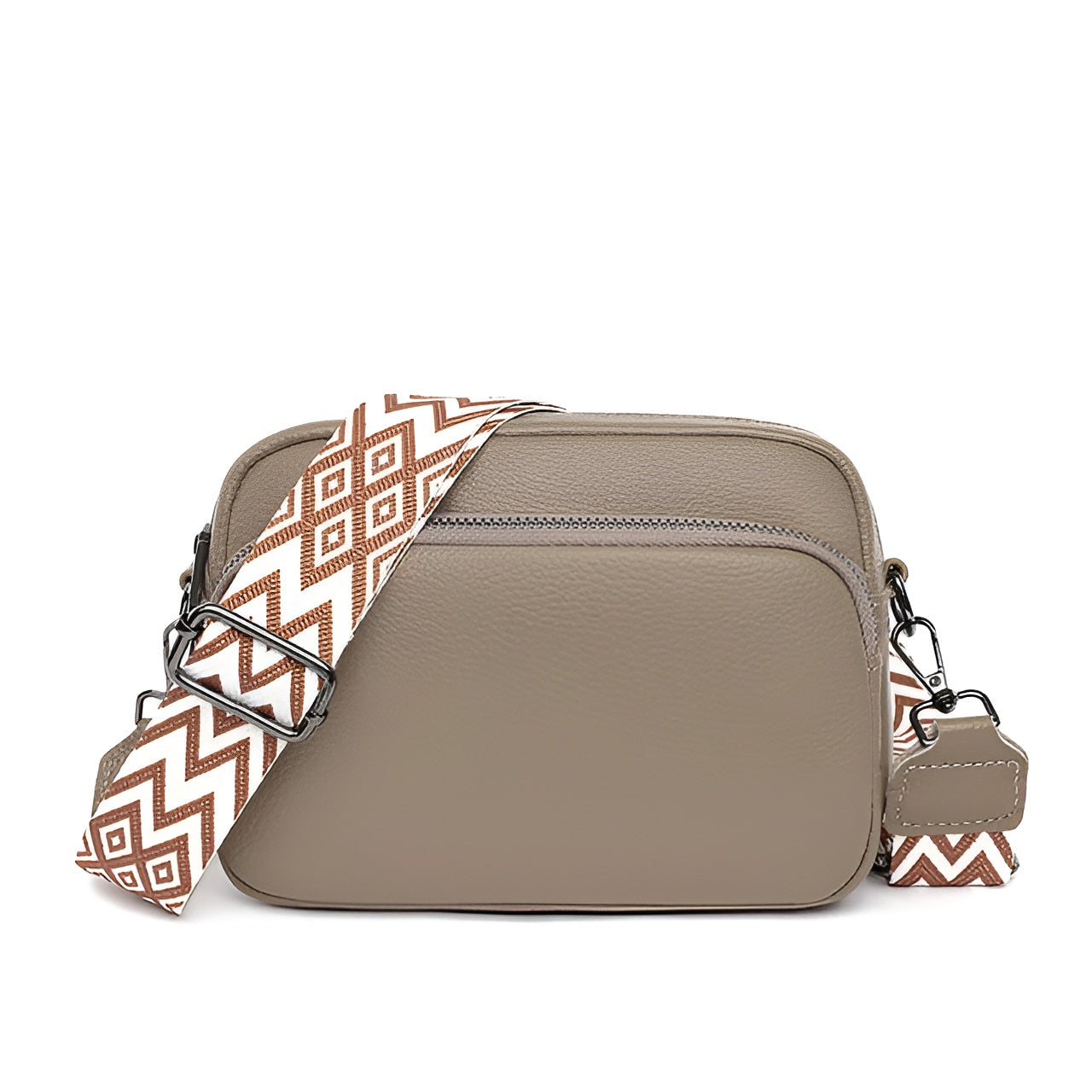 Taupe leather crossbody bag with geometric patterned strap, featuring a front zipper pocket and detachable keychain. Stylish women's accessory.