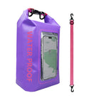 Purple waterproof dry bag with clear phone pocket, pink strap, and bold "WATER PROOF" text. Ideal for outdoor activities, kayaking, and hiking.