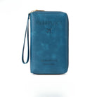 Blue leather travel wallet with embossed "Passport" text and airplane icon, featuring a wrist strap. Ideal for organizing travel documents securely.