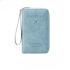 Light blue leather travel wallet with embossed "Passport" text and airplane icon, featuring a wrist strap. Ideal for organizing travel documents.