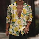 Man wearing a stylish lemon print shirt with rolled-up sleeves, open front, and casual accessories. Trendy summer fashion, men's casual wear.