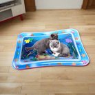 Two kittens play on a colorful inflatable water mat with ocean-themed designs, perfect for interactive pet entertainment and sensory stimulation.