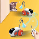 Interactive cat toy with remote control, featuring colorful tassels and wheels, engaging a curious kitten on a yellow background. Perfect for pet play.