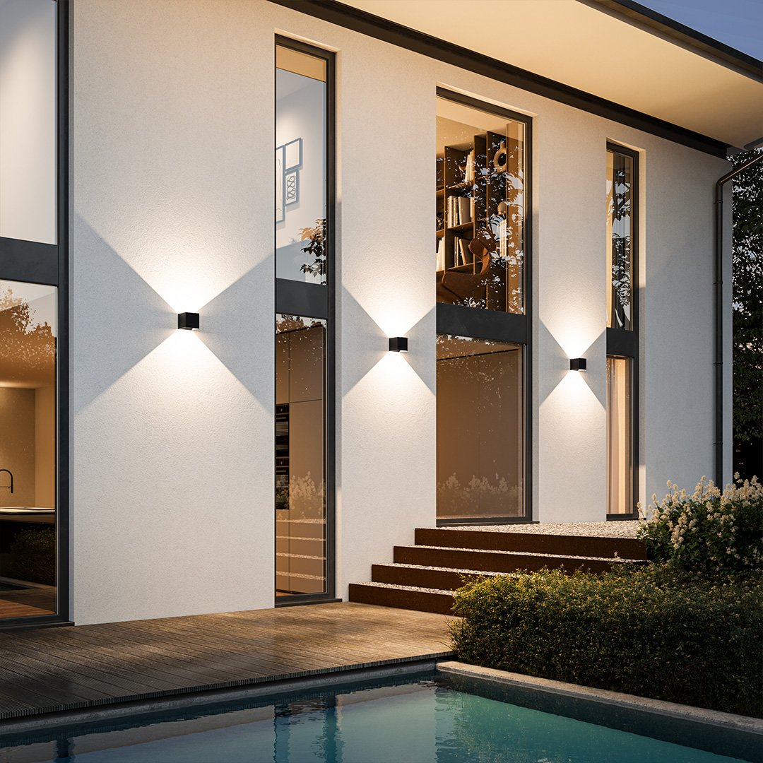 Modern minimalist house exterior with large windows, sleek wall lights, and a pool. Contemporary architecture, luxury home design, outdoor lighting.